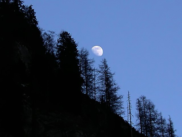 Moon rising over italian Dolomites mountains